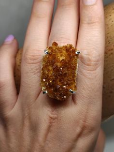 Make a Bold Statement with our Raw Citrine Ring! Elevate your style and showcase your unique personality with our exceptional Raw Citrine Ring. Crafted with a genuine, uncut citrine gemstone, this ring embodies the raw beauty of nature. The adjustable band ensures a perfect fit for any finger, providing both comfort and versatility. Made with sterling silver filled metal, this ring offers durability and a lustrous shine that complements the radiant citrine stone. Citrine is revered for its abili Spiritual Amber Citrine Rings, Unique Citrine Gemstone Rings, Unique Citrine Gemstone Crystal Ring, Citrine Stone Ring Jewelry, Citrine Stone Ring, Citrine Ring With Large Stone, Citrine Gemstone Crystal Promise Ring, Citrine Crystal Promise Ring With Gemstone, Gold Rings With Natural Stones And Citrine