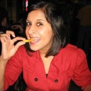 a woman in a red shirt is eating food