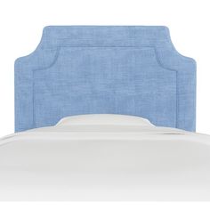 an upholstered blue headboard on a white bed