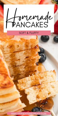 pancakes stacked on top of each other with blueberries and strawberries in the background