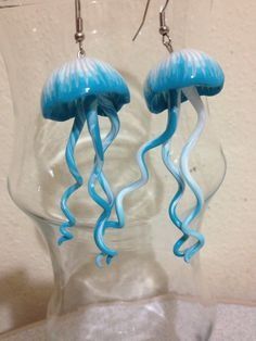 blue and white jellyfish earrings in a clear vase