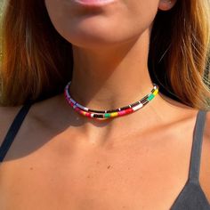 Bundle includes 2 chokers worn by Kiara in Season 1 of OBX. Each choker is handmade with African Vinyl Record Beads Choker 1 - Black and White Beads Choker 2 - Salmon/Multi Rasta Beads Gold Plated Brass Clasp Closure & Signature EF tag Measures 12.5 inches with 3 inch extender Globally and Ethically sourced Large Beads Festival Choker, Festival Large Beads Choker, Festival Choker With Large Beads, Festival Beaded Choker With Large Beads, Festival Large Bead Choker Necklace, Festival Heishi Beads Choker Necklace, Multicolor Beaded Choker With Black Beads, Festival Black Choker With Large Beads, Black Festival Choker With Large Beads