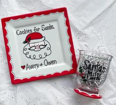 two christmas themed cookies for santa and averyy and ovenn on a white tablecloth