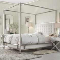 a white bed sitting in a bedroom on top of a rug