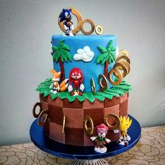 a sonic birthday cake is decorated with mario and friends figurines on the top