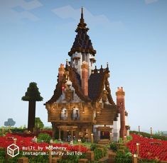 a large wooden house in the middle of a field full of red flowers and trees