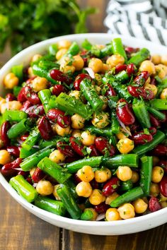 a white bowl filled with beans and green beans