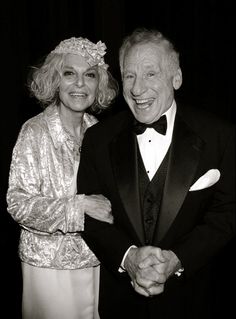 an older man and woman dressed in formal wear