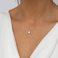 This delicate necklace features a single teardrop-shaped crystal hanging delicately from an elegant silver chain. The crystal is beautifully faceted, catching and reflecting light with every movement, while the silver chain adds an extra level of sparkle and sophistication. The perfect addition to any outfit, the Crystal Teardrop Necklace will add a touch of glamour and sophistication, making you look and feel your best. Silver Wedding Necklace, Minimalist Teardrop Necklace With Brilliant Cut, Minimalist Teardrop Brilliant Cut Necklace, Solitaire Teardrop Pendant Necklace, Minimalist Solitaire Necklace With Teardrop Diamond Cut Pendant, White Teardrop Drop Necklace With Brilliant Cut, White Teardrop Cubic Zirconia Solitaire Necklace, White Teardrop Solitaire Necklace In Cubic Zirconia, White Teardrop Brilliant Cut Drop Necklace