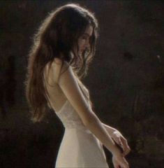 a woman in a white dress holding a knife