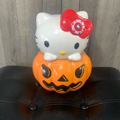 a hello kitty pumpkin sitting on top of a chair