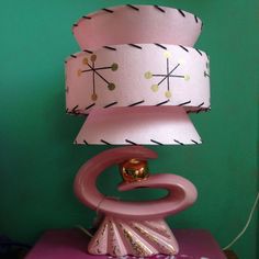 a pink lamp sitting on top of a purple table