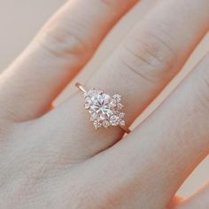 a woman's hand with a diamond ring on it