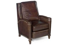 a brown leather recliner chair with nail polishing on the armrests and foot rest