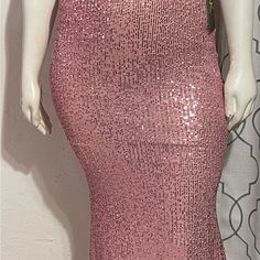 a mannequin wearing a pink sequin dress