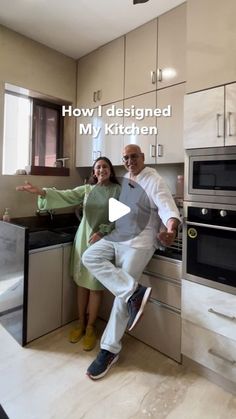 the man and woman are posing for a photo in front of the kitchen counter top