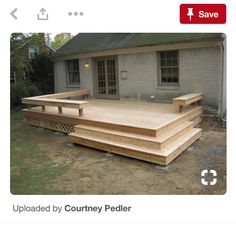 a large wooden deck in front of a house