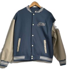 Urban Style Blue Varsity Jacket For Fall, Blue Urban Varsity Jacket For Fall, Urban Blue Outerwear With Baseball Collar, Blue Outerwear With Baseball Collar For Spring, Blue Casual Varsity Jacket For Outdoor, Casual Blue Varsity Jacket For Outdoor, Casual Blue Outerwear With Baseball Collar, Navy Casual Varsity Jacket For Outdoor, Blue Baseball Collar Outerwear For Fall