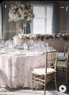 the table is set with white and pink flowers