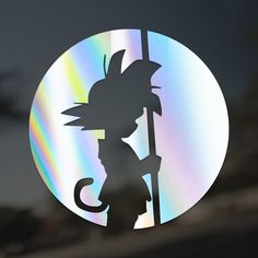 the shadow of a person holding a sticker in front of a circular background with an image of a dragon on it