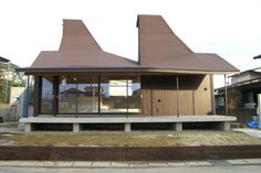 a small building with three pointed roof tops