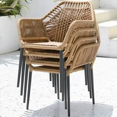 a stack of chairs sitting on top of a white tiled floor