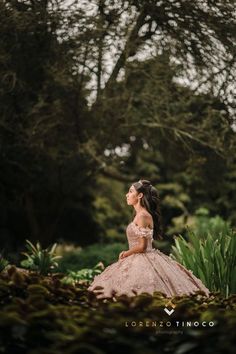 a woman in a dress is sitting on the ground and looking up into the sky