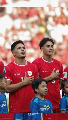 a group of soccer players standing next to each other