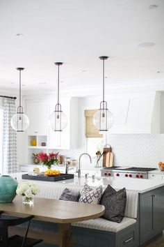 a kitchen filled with lots of counter top space and furniture next to a dining room table