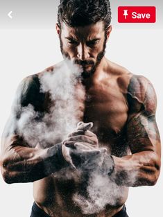 a shirtless man is holding his hands in front of the camera with steam coming out of it