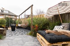 an outdoor patio with hammock chairs and potted plants in the back yard