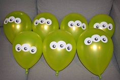 green balloons with googly eyes on them