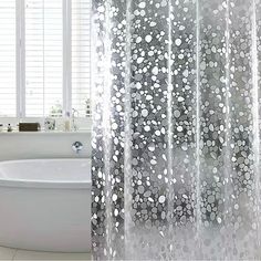 a white bath tub sitting next to a shower curtain