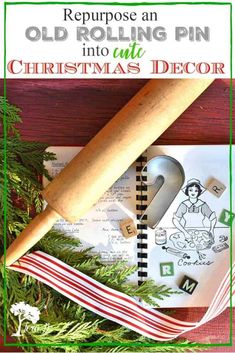 an old rolling pin is sitting on top of a christmas card and some other items