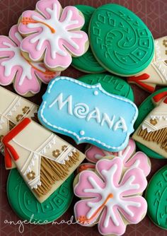 decorated cookies are arranged in the shape of flowers and leaves with name written on them