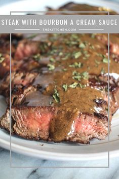 steak with bourbon and cream sauce on a white plate