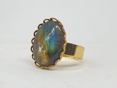 Oval semi-precious Brazilian Blue Labradorite ring, adjustable size gold-plated finish ring. This is a stunning ring made with a very beautiful semi-precious Brazilian Blue Labradorite stone, with beautiful dark blue-copper flashes.  The ring is fully adjustable and can be sized very easily from sizes UK N to V (US 6 1/2 - 10 5/8; EU 54 - 63) (the ring can be supplied sized smaller on request).  It is made using a lovely 18mm x 13mm oval stone to create a beautifully proportioned  ring.  The rin Precious Stones Rings, Labradorite Ring, Blue Labradorite, Oval Stone, Gold Plated Rings, Labradorite Stone, Lace Edging, Gemstone Ring, Rings Statement