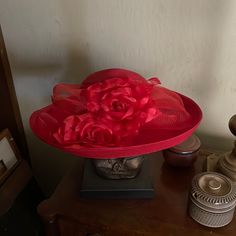 Straw Hat In The Color Red With Flowers And A Few Feathers To Accent It. Great For Summer Wear. Red Mini Hats For Spring Beach Outings, Red Brimmed Mini Hat For The Beach, Red Brimmed Mini Hat For Beach, Red Mini Hats For Beach In Spring, Red Brimmed Hat For Church, Red Short Brim Hats For Church, Red Brimmed Church Hat, Elegant Red Mini Hat With Flat Brim, Red Adjustable Sun Hat For Kentucky Derby