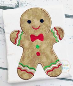 a gingerbread man applique on a white shirt