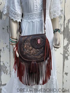 Show your personality with the Crystal Moon Leather Fringed Boho bag. The Crystal Moon bag is a stunning piece. A Beautiful Hand tooled bohemian style bag with a feature gem, a must for any bohemian wardrobe. Handmade Genuine Leather Magnetic Close on front flap, zipper close inside under flap. Inside bag- Zip pocket and 2 open pockets Lined Measurements - Approx W26cm x H26cm Strap length Approx - 124cm Colour -Tan or chocolate Please keep in mind that leather is a natural product and colour va Bohemian Brown Hobo Bag, Bohemian Bags For Everyday Use, Bohemian Brown Shoulder Bag, Bohemian Leather Bag With Tassels, Bohemian Leather Crossbody Hobo Bag, Bohemian Leather Hobo Bag In Crossbody Style, Bohemian Hobo Bag With Tassels, Bohemian Brown Shoulder Bag For Festival, Handmade Bohemian Leather Shoulder Bag