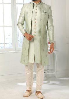 Readymade Art Silk Sherwani, and Jacket. Art Dupion Aligarhi Ready Made Trouser. Resham, Sequences, and Zari Work. Crafted in Chinese Collar Neck, and Full Sleeve. Faux Satin Lining with Plain Work. High-Quality Matching Buttons. Please Note: The footwear shown in the picture is for presentation and photography purpose only. Color: There might be slight color variation due to lightings and flashes while photo shooting. The color may also vary because of different screen resolutions. Wash Care: D Fitted Long Outerwear For Festive Season, Pista Green Long Sleeve Unstitched Suit For Wedding, Festive Long Fitted Outerwear, Elegant Festive Straight Kurta Outerwear, Traditional Fitted Long Coat, Festive Long Outerwear With Resham Embroidery, Formal Raw Silk Nehru Jacket With Traditional Drape, Eid Nehru Jacket With Cutdana On Raw Silk, Formal Nehru Jacket In Raw Silk