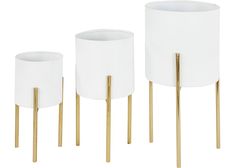 three white vases with gold legs on a white background