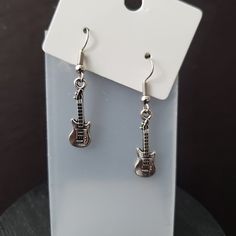 This adorable earrings are perfect for a Guitar lover. Great for a rock concert.  24 x 7 mm Punk Metal Earrings For Concerts, Silver Punk Earrings For Concert, Punk Style Metal Earrings For Concert, Nickel-free Silver Jewelry For Concerts, Edgy Pierced Earrings For Concerts, Adjustable Hypoallergenic Punk Jewelry, Silver Nickel-free Music-themed Earrings, Nickel-free Metal Music-themed Jewelry, Nickel-free Music-themed Metal Jewelry