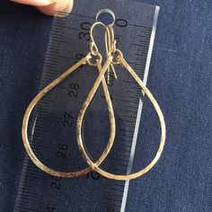 "Everybody will notice these hoops on you because they reflect light in a really beautiful way. These hoops sparkle and are hand shaped, hammered, and polished to a glittering finish. The hammering gives the surface of the sterling wire a glittering effect. The entire earring is apprx 1 7/8\". The hoop length alone is apprx 1.5\". These are shown with Gold Filled french ball earwires. I can attach any stone or stones in my vast treasure trove that will fit, dangling from a chain, so please conta Gold Hammered Teardrop Earrings, Gold Teardrop Hammered Earrings, Everyday Gold Teardrop Hoop Earrings, Handmade Teardrop 14k Gold Hoop Earrings, Hammered Yellow Gold Dangle Hoop Earrings, Yellow Gold Teardrop Hoop Earrings With Ear Wire, Yellow Gold Dangle Hoop Earrings With Hammered Texture, Yellow Gold Hammered Dangle Hoop Earrings, Hammered Teardrop Earrings For Anniversary