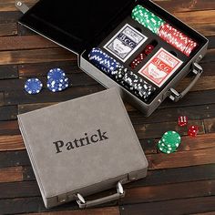 an open box with poker chips and dices in it sitting on a wooden table