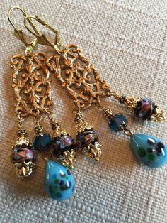 Vintage Blue Millefiori with Flowers Pendants. Vintage Blue Wedding Cake Beads Vintage Blue Cathedral Beads. Vintage Brass Leverback Closure Size  :     2 3/4  inches     ( 7 cm) Nickel Free Czech Glass Wedding Jewelry, Nickel-free Czech Glass Earrings For Wedding, Nickel-free Czech Glass Wedding Earrings, Elegant Beaded Earrings With Bead Caps For Wedding, Ornate Turquoise Jewelry For Wedding, Ornate Blue Dangle Earrings, Adjustable Czech Glass Jewelry For Wedding, Elegant Turquoise Chandelier Earrings With Round Beads, Blue Ornate Dangle Earrings