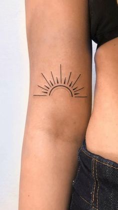 two women with tattoos on their arms and one has a sun tattoo on her arm