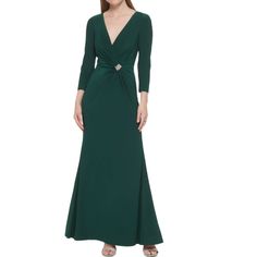 a woman in a long green dress with a knot on the waist and sleeves,