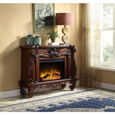 a living room with a fire place in the center and a rug on the floor