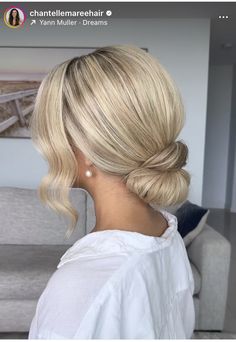 a woman with blonde hair in a low bun